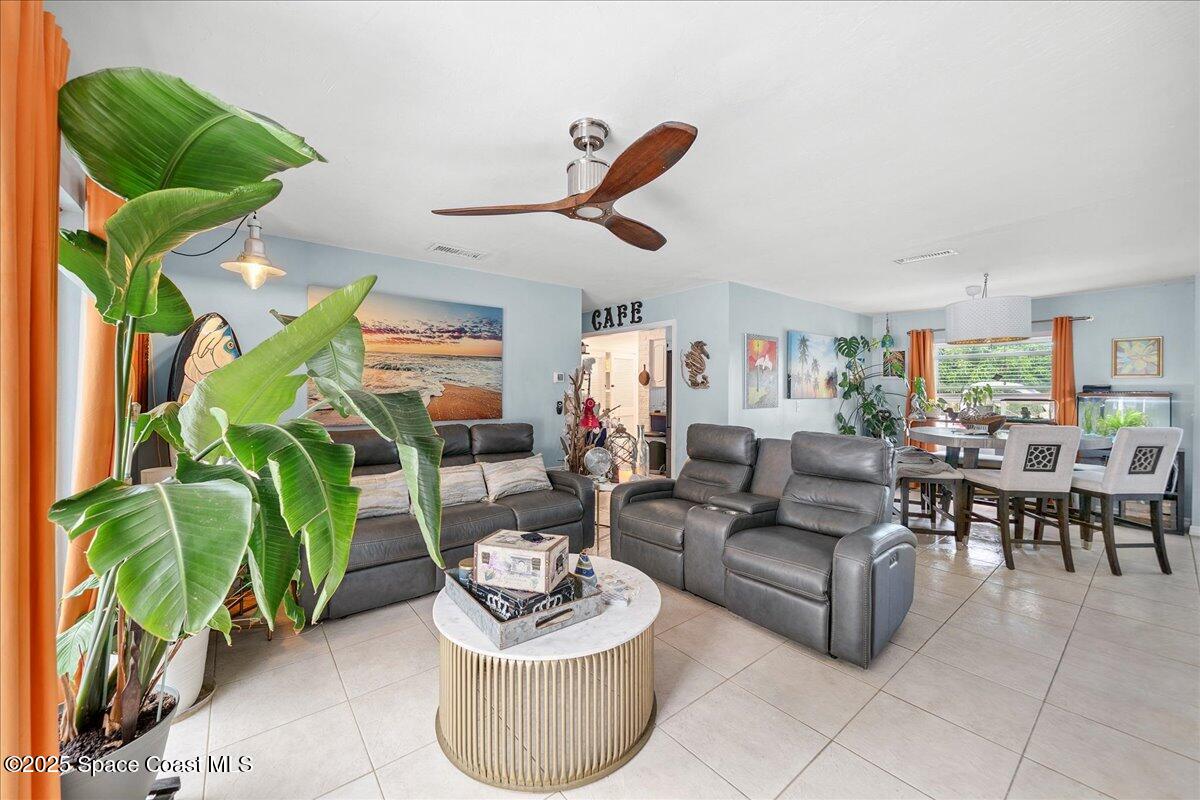 1405 Fiddler Avenue Merritt Island, FL 32952 - Photo 8 of 43 a living room with furniture a rug and a chandelier
