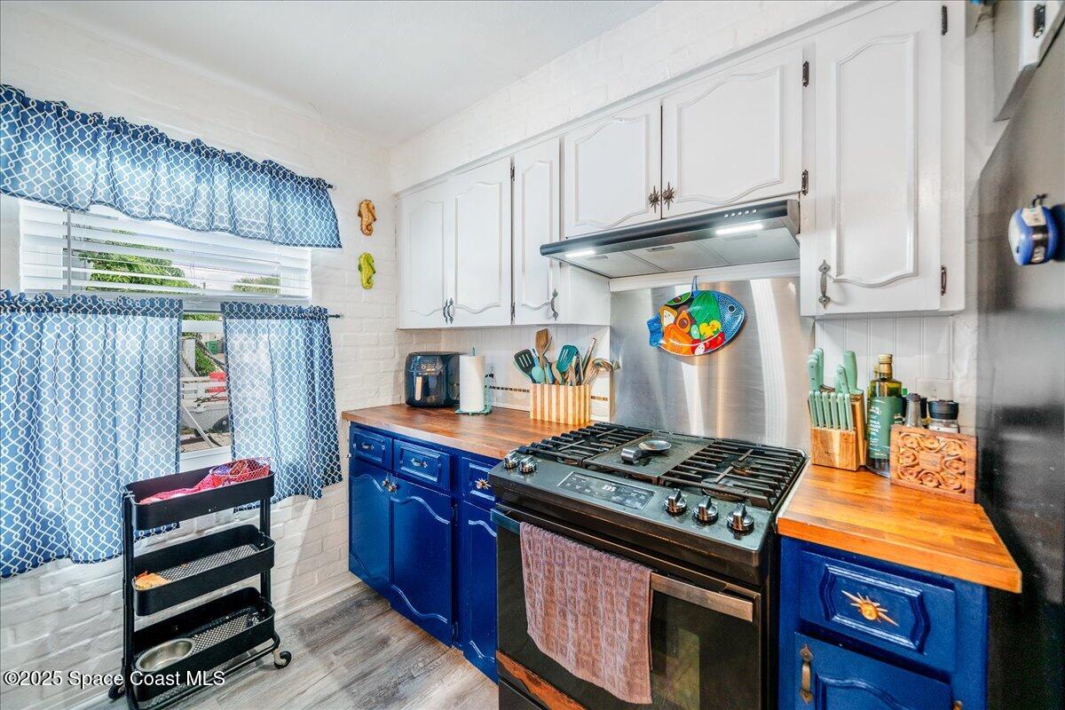 1405 Fiddler Avenue Merritt Island, FL 32952 - Photo 9 of 43 a kitchen with stainless steel appliances granite countertop a stove and a refrigerator