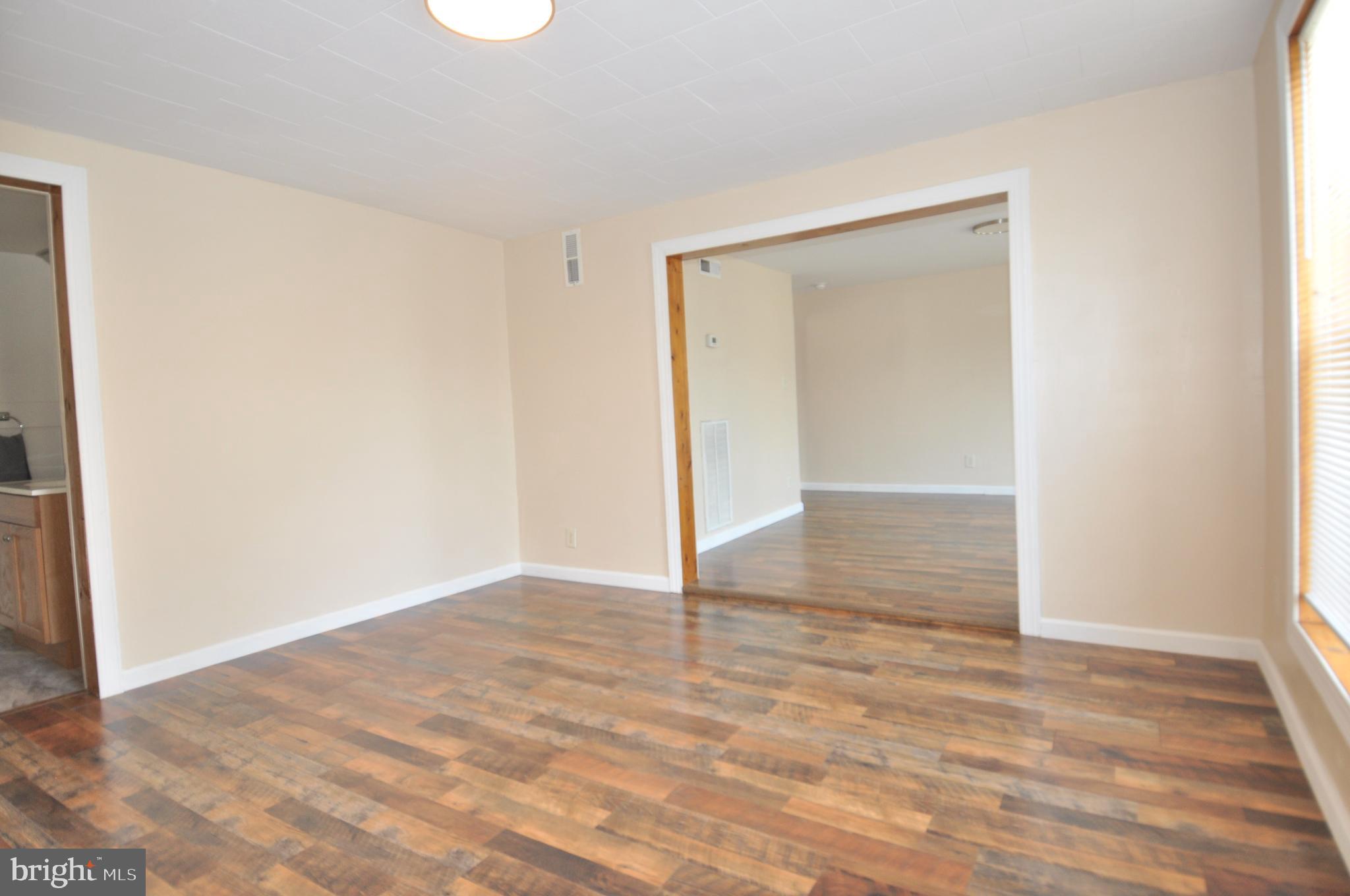 601 4th Street Pocomoke City, MD 21851 - Photo 14 of 35 an empty room with wooden floor and windows
