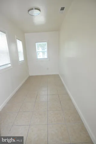 an empty room with windows and entrance