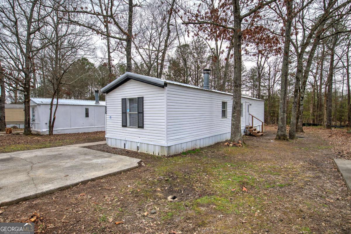 65 Tency Lane Northeast Rome, GA 30165 - Photo 17 of 20 a view of a house with a yard and garage
