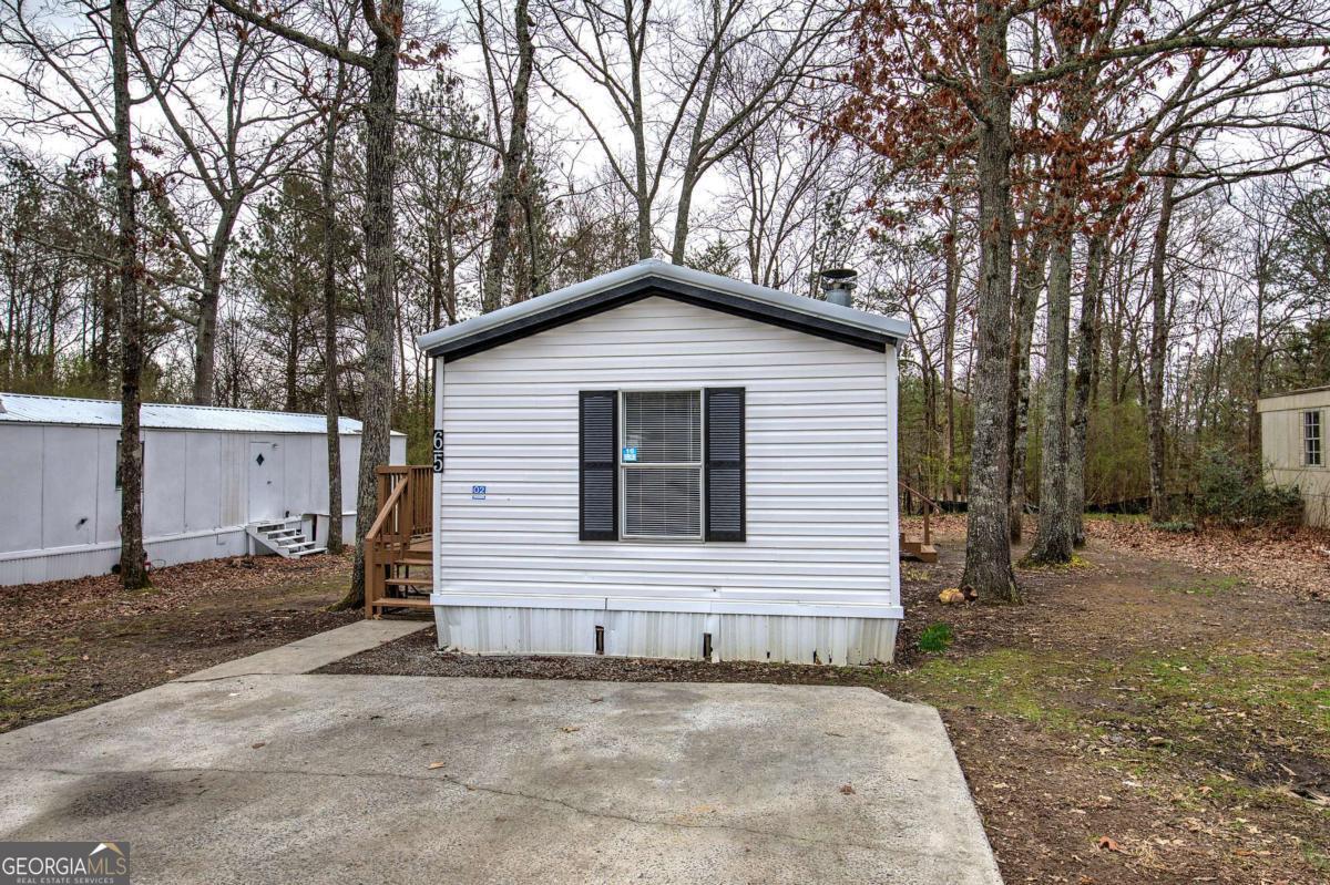 65 Tency Lane Northeast Rome, GA 30165 - Photo 18 of 20 a house with trees in the background