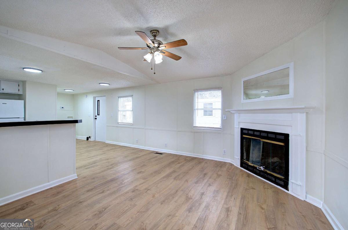65 Tency Lane Northeast Rome, GA 30165 - Photo 6 of 20 a view of an empty room with a fireplace and a window