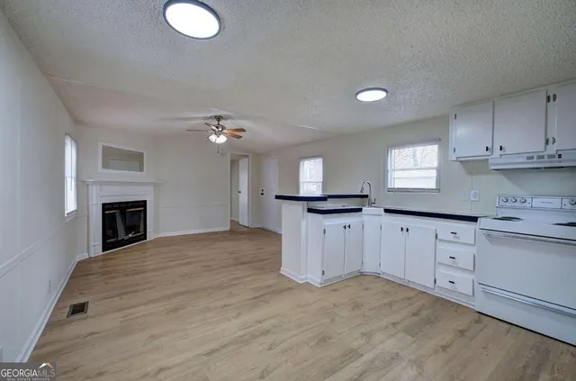 a kitchen with cabinets and window