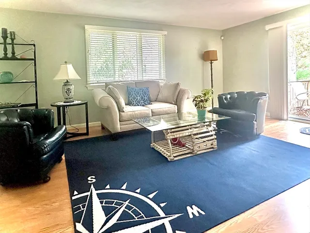 a big room with wooden floor and windows