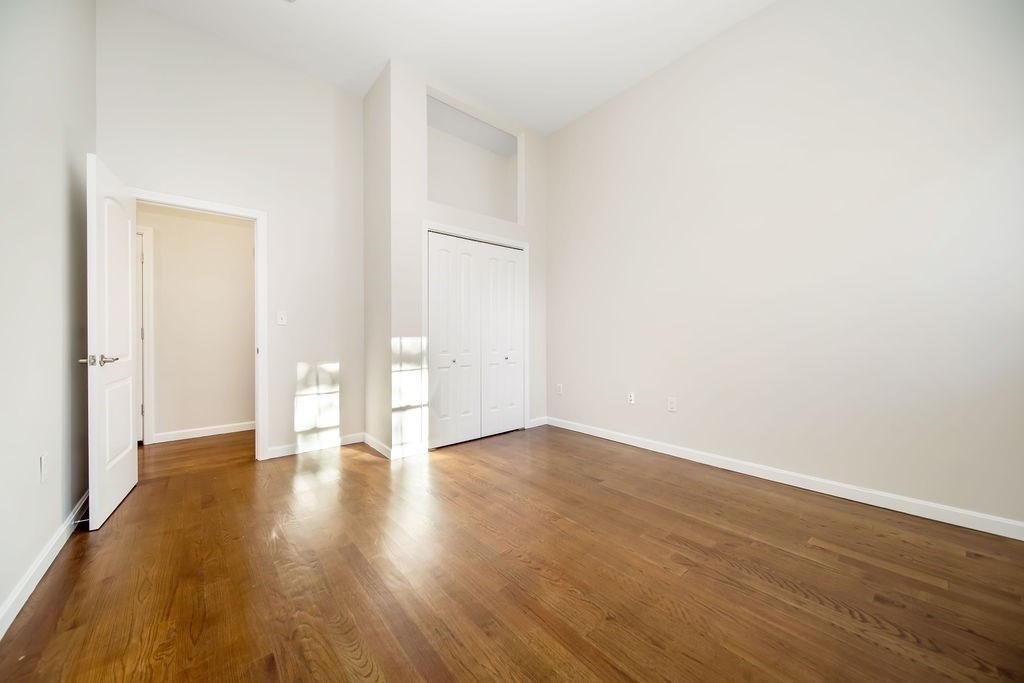 81 Broadway, Unit 1 Chelsea, MA 02150 - Photo 18 of 29 a view of an empty room and wooden floor