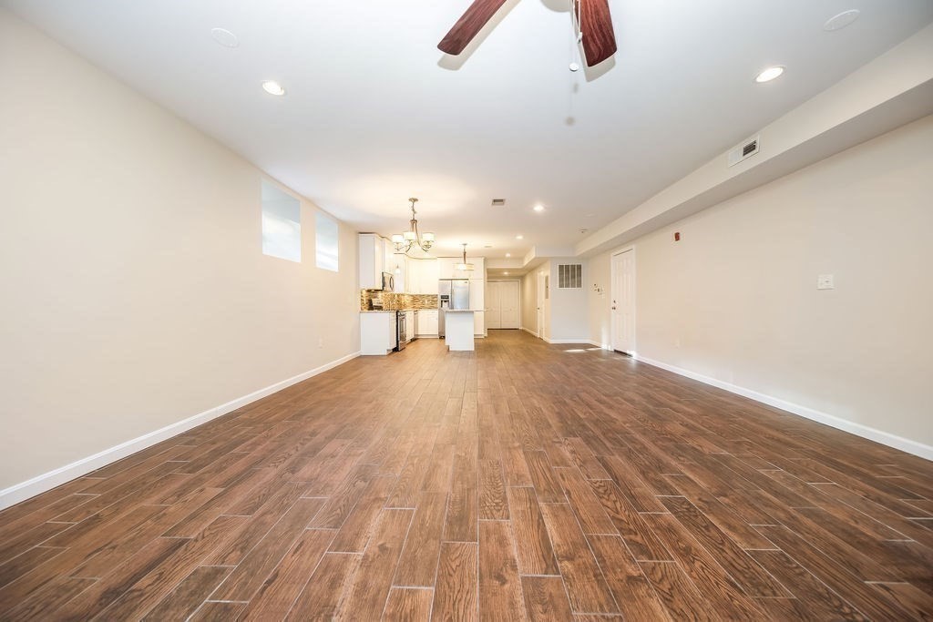 81 Broadway, Unit 1 Chelsea, MA 02150 - Photo 9 of 29 a view of empty room with wooden floor