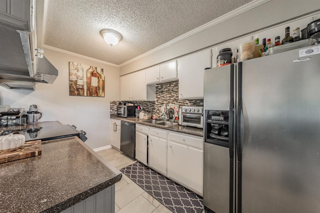 623 Ridgeline Drive Hurst, TX 76053 - Photo 11 of 29 a kitchen with stainless steel appliances granite countertop a sink stove and refrigerator