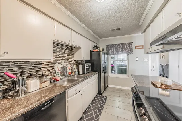 a kitchen with stainless steel appliances granite countertop a sink stove and cabinets