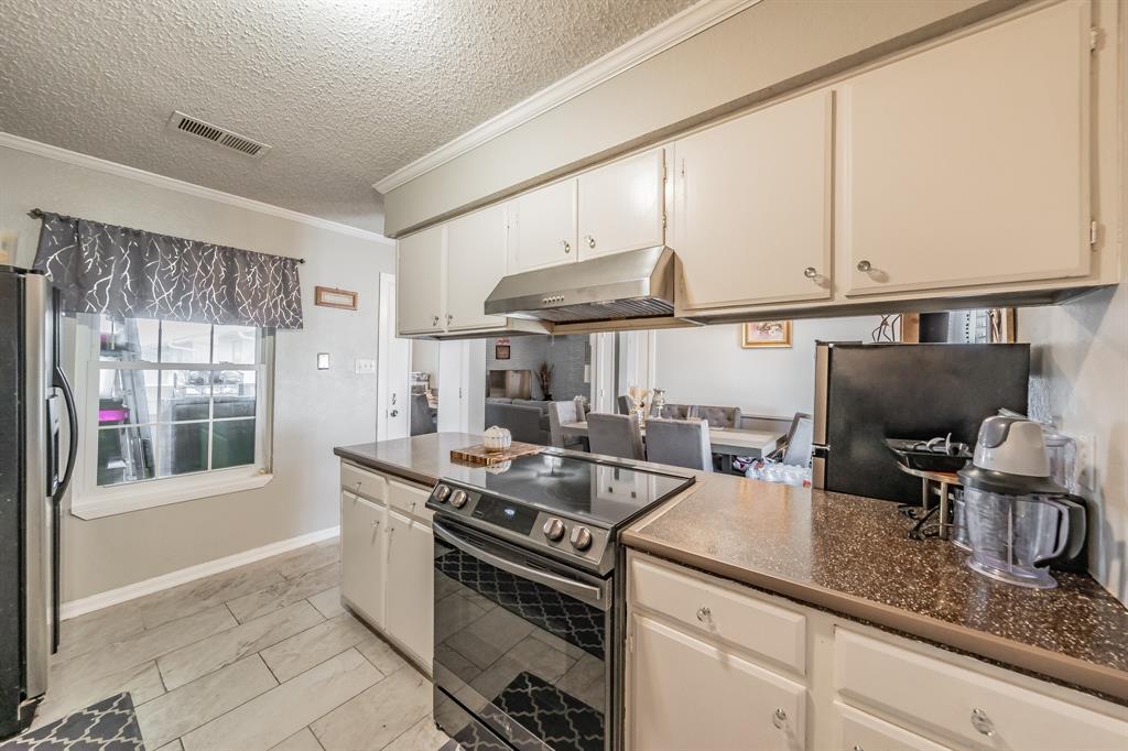 623 Ridgeline Drive Hurst, TX 76053 - Photo 14 of 29 a kitchen with stainless steel appliances granite countertop a sink stove and cabinets