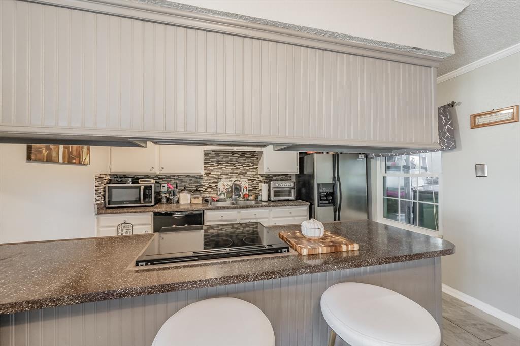 623 Ridgeline Drive Hurst, TX 76053 - Photo 15 of 29 a kitchen with a table chairs and cabinets