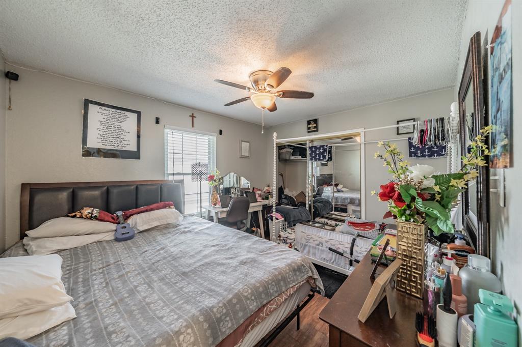 623 Ridgeline Drive Hurst, TX 76053 - Photo 16 of 29 a bedroom with furniture and a chandelier