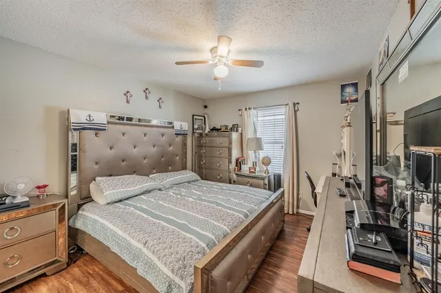 a bedroom with a bed and a television