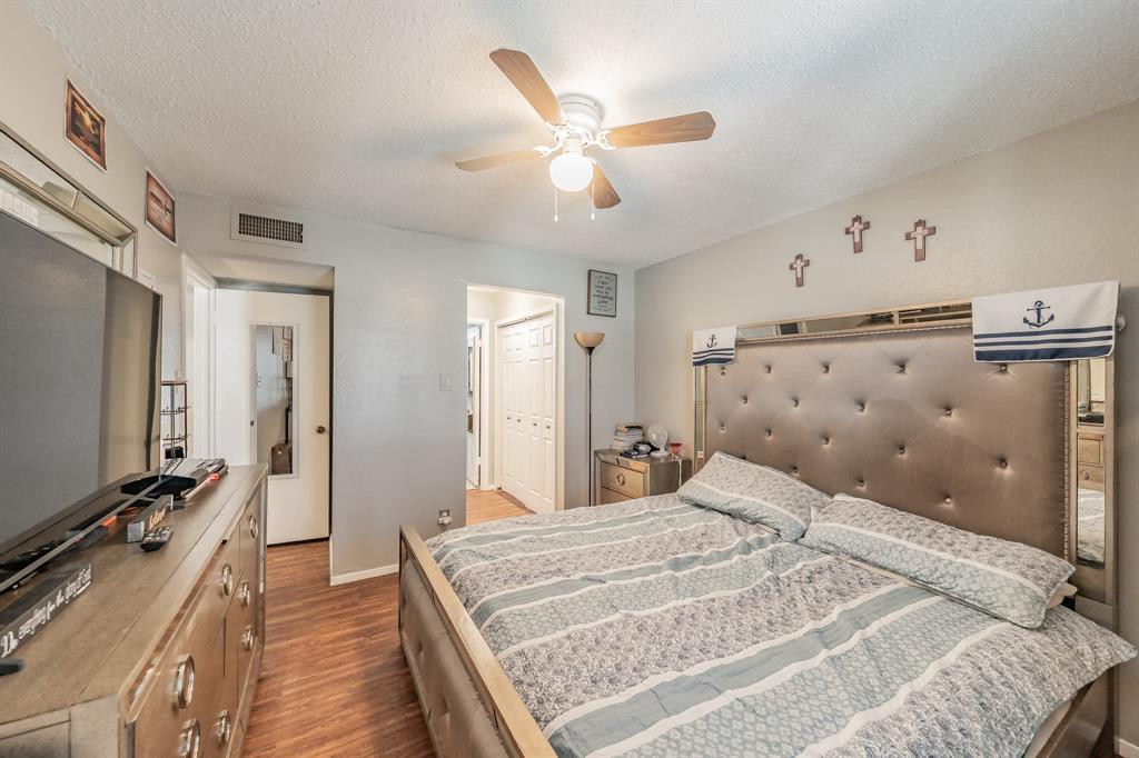 623 Ridgeline Drive Hurst, TX 76053 - Photo 20 of 29 a bedroom with a large bed and a flat tv screen on dresser