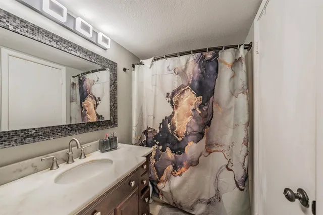 a bathroom with a toilet and a shower curtain