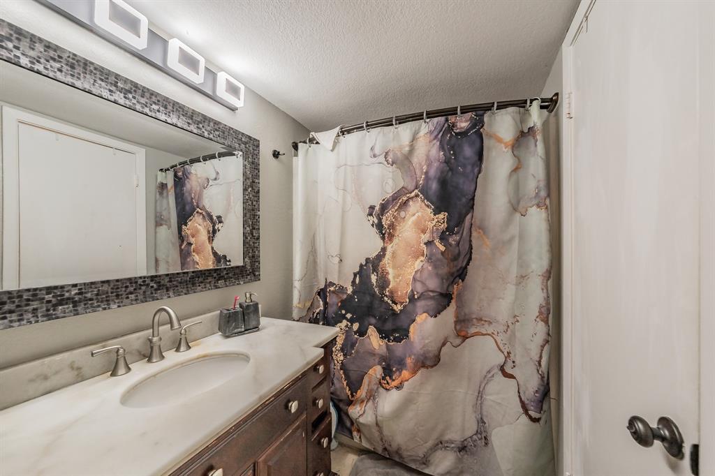 623 Ridgeline Drive Hurst, TX 76053 - Photo 21 of 29 a bathroom with a sink vanity and a mirror