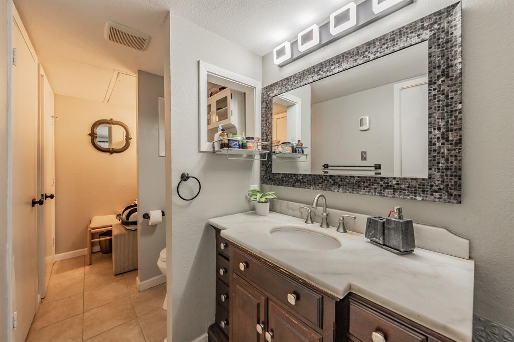623 Ridgeline Drive Hurst, TX 76053 - Photo 24 of 29 a bathroom with a sink and a mirror