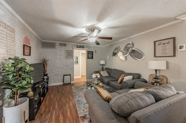 a living room with furniture and a potted plant