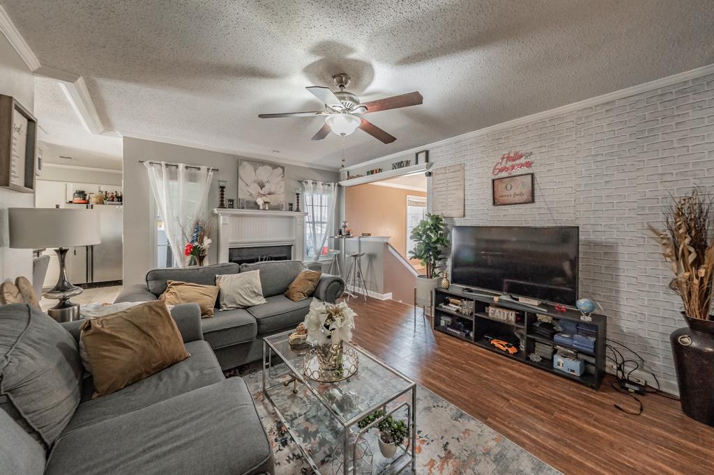 623 Ridgeline Drive Hurst, TX 76053 - Photo 7 of 29 a living room with furniture a flat screen tv and a fireplace