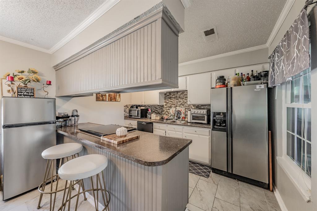 623 Ridgeline Drive Hurst, TX 76053 - Photo 10 of 29 a kitchen with refrigerator and chairs