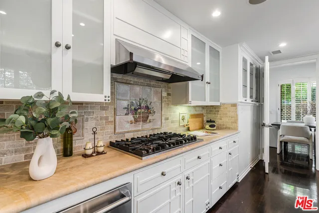 a kitchen with sink a stove and cabinets