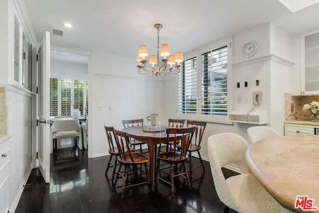 a view of a dining room with furniture wooden floor and chandelier