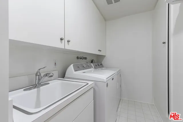 a utility room with sink dryer and washer