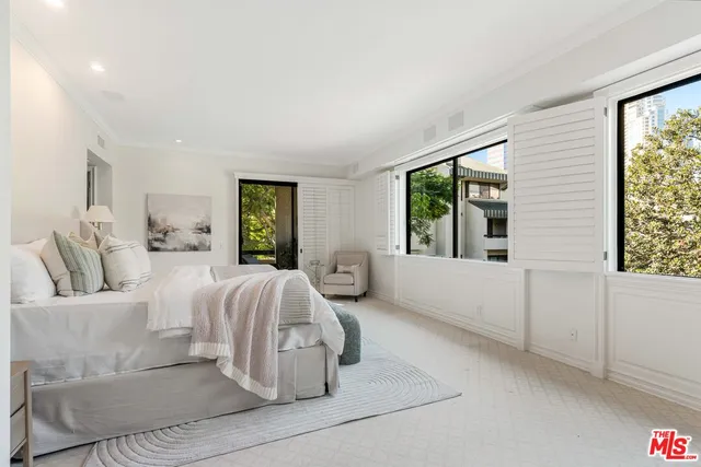 a bedroom with a large bed and a large window