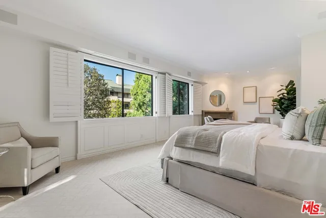 a outdoor living room with furniture and a potted plant