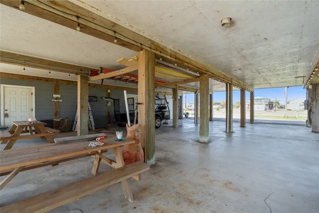 an aerial view of ocean and residential houses with outdoor space