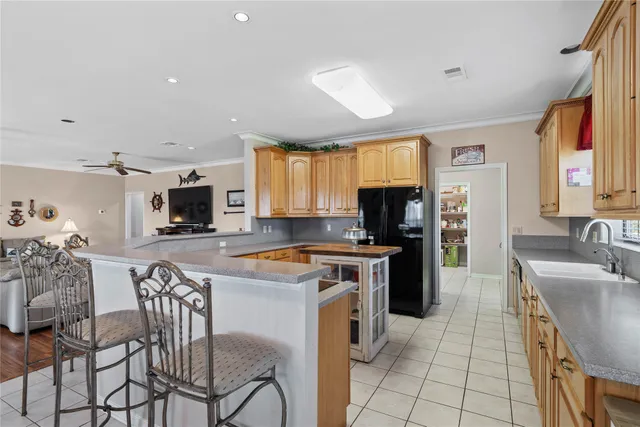 a kitchen with granite countertop a sink window and cabinets