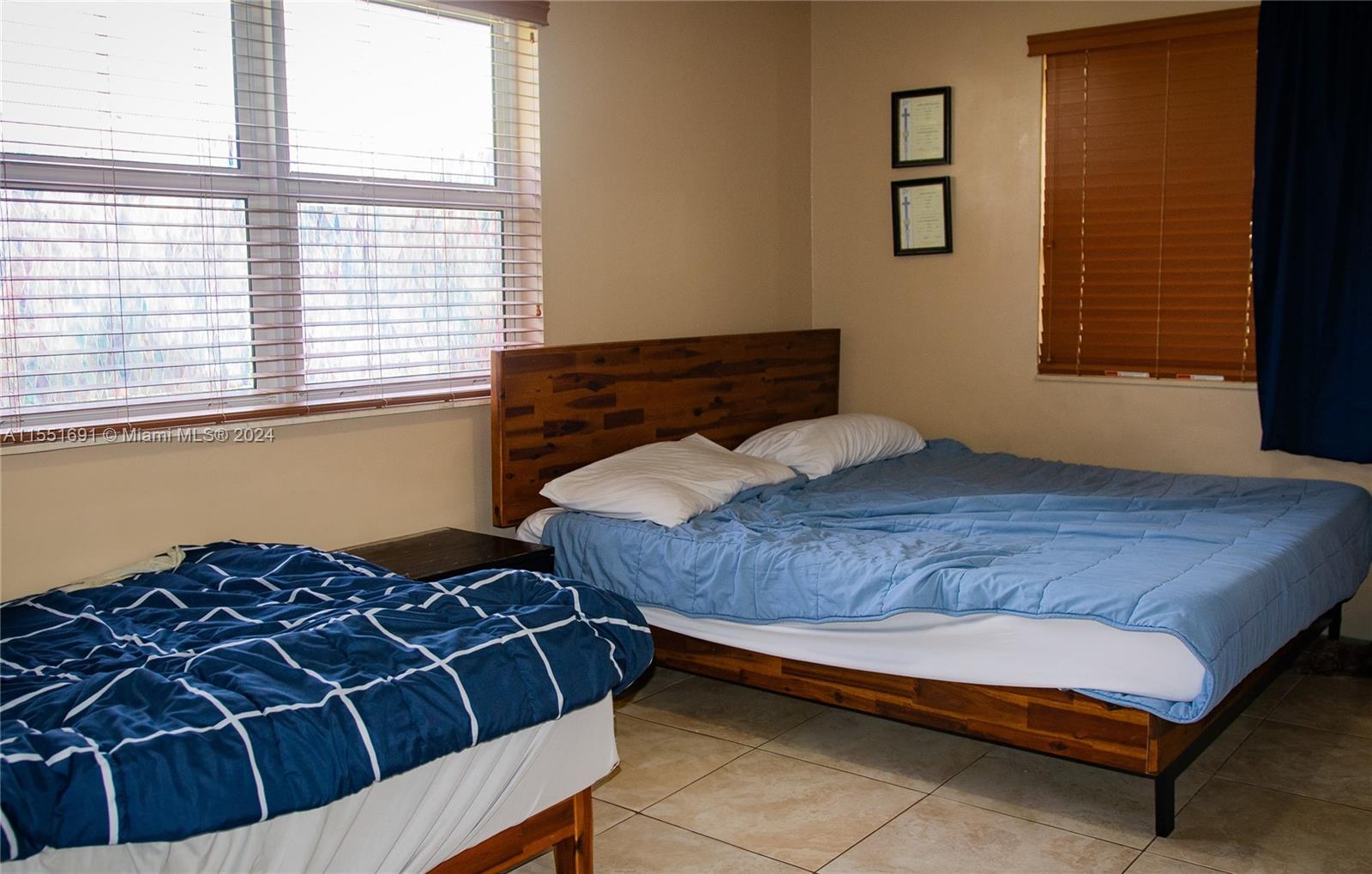 6005 Southwest 22nd Street Miami, FL 33155 - Photo 20 of 36 a bedroom with a bed and window