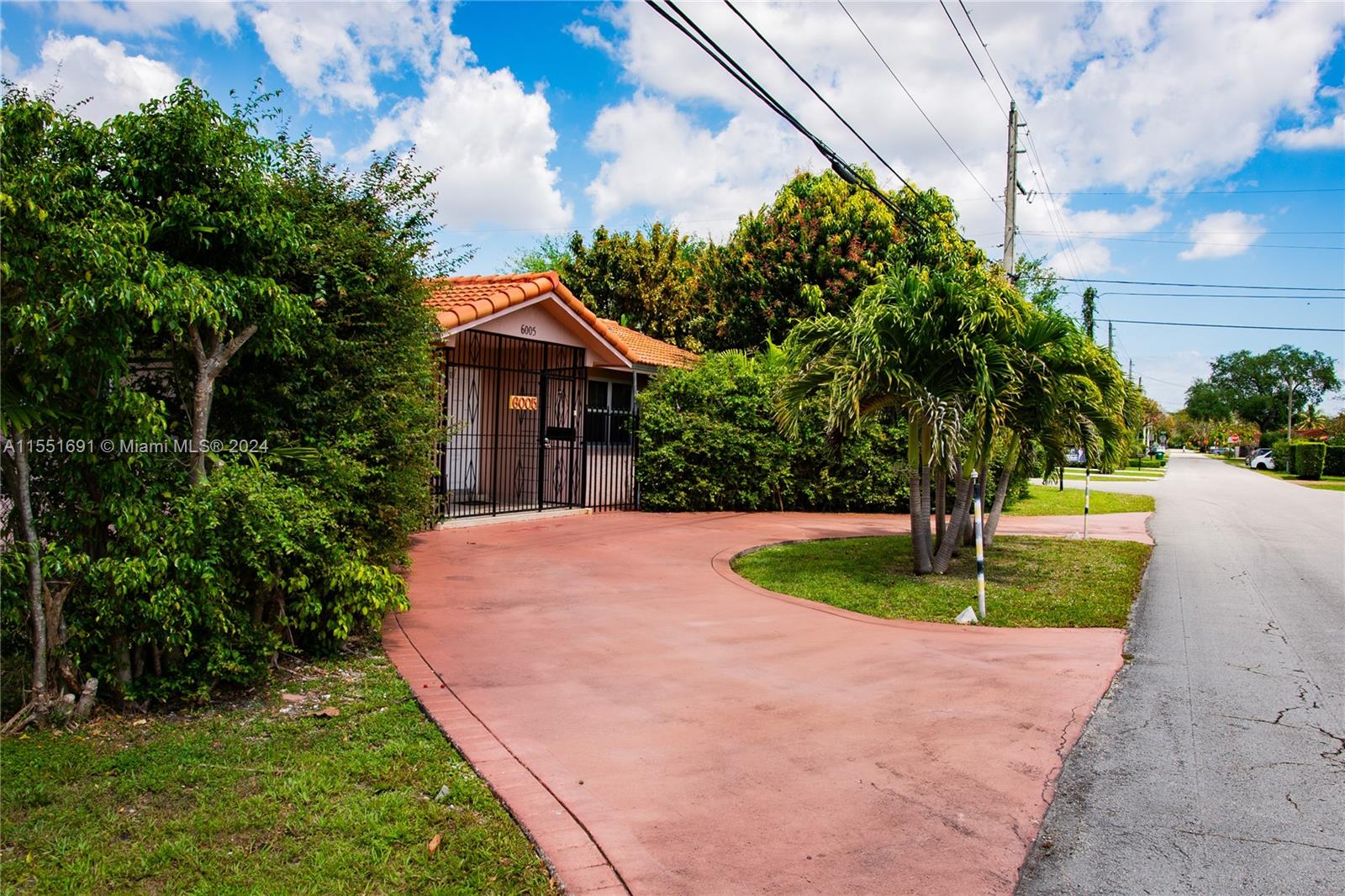 6005 Southwest 22nd Street Miami, FL 33155 - Photo 2 of 36 a front view of a house with a yard and trees