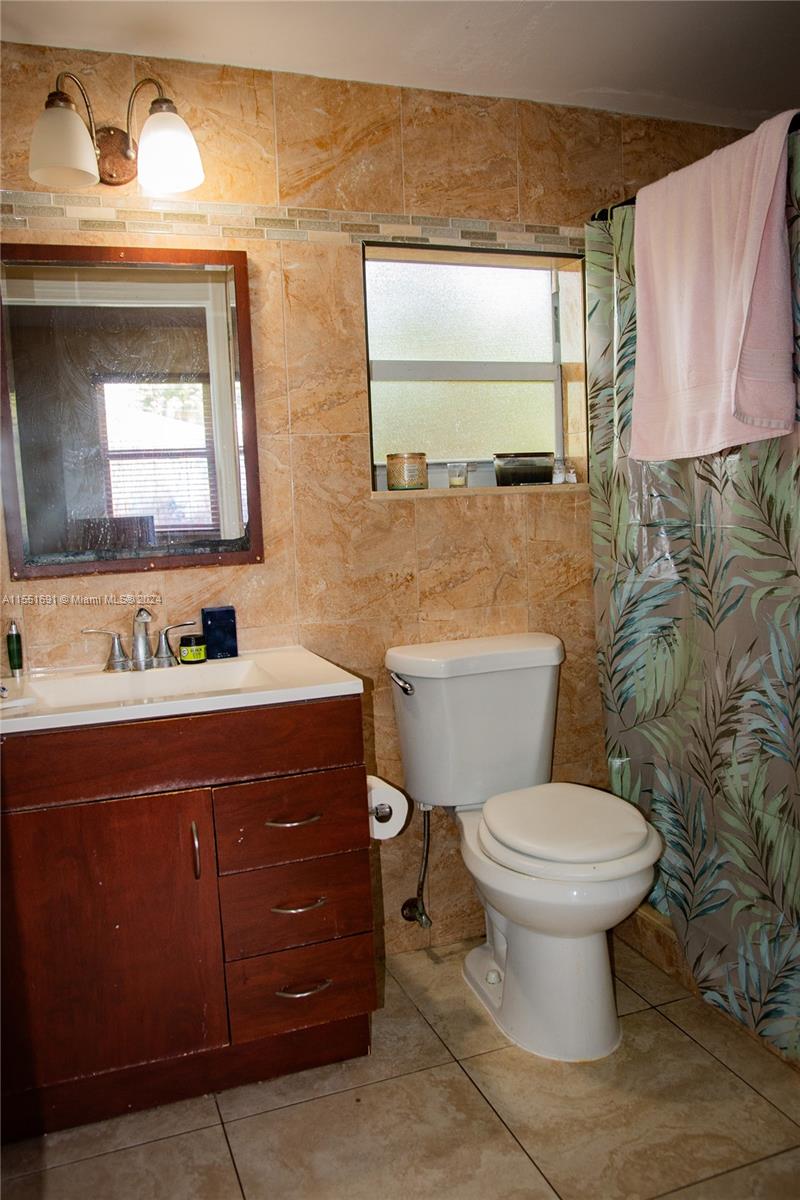 6005 Southwest 22nd Street Miami, FL 33155 - Photo 21 of 36 a bathroom with a toilet sink and mirror
