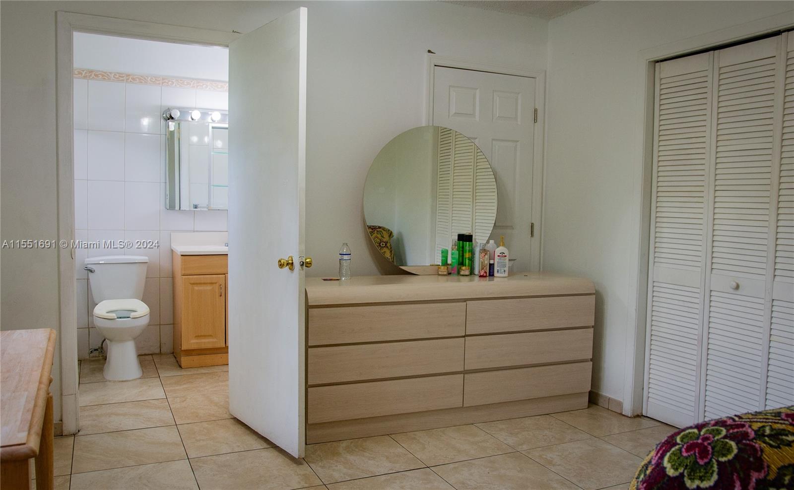 6005 Southwest 22nd Street Miami, FL 33155 - Photo 23 of 36 a bathroom with a sink a toilet and mirror