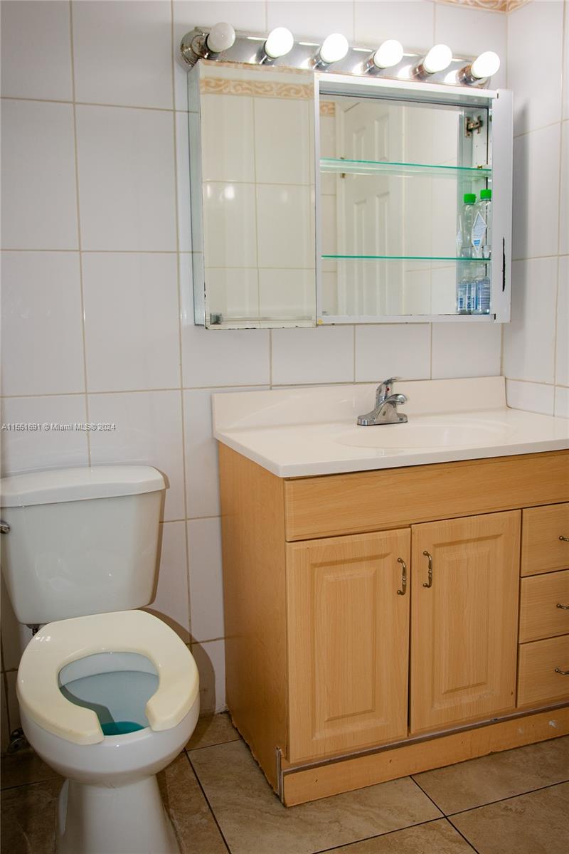 6005 Southwest 22nd Street Miami, FL 33155 - Photo 26 of 36 a bathroom with a sink a toilet and mirror