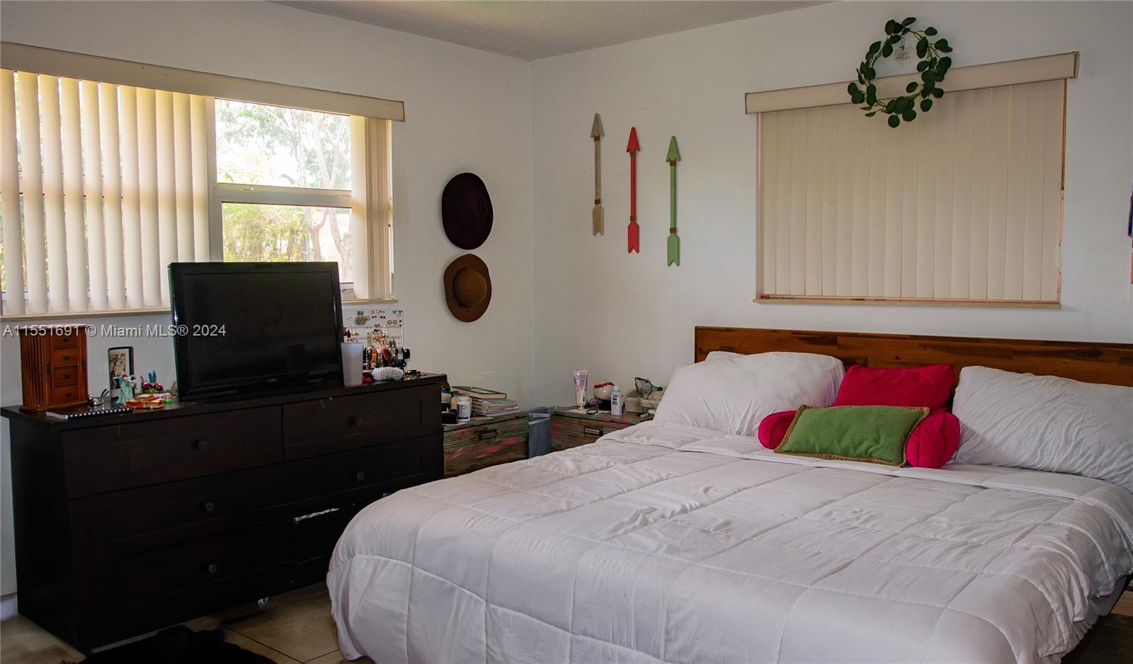 6005 Southwest 22nd Street Miami, FL 33155 - Photo 29 of 36 a bedroom with a bed and cabinets