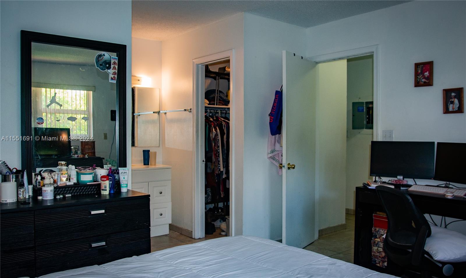 6005 Southwest 22nd Street Miami, FL 33155 - Photo 30 of 36 a bedroom with a bed and a flat tv screen on dresser