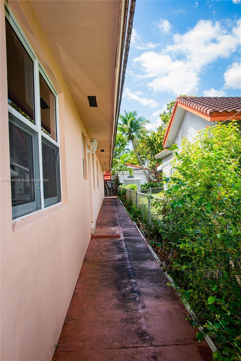 6005 Southwest 22nd Street Miami, FL 33155 - Photo 4 of 36 a path view of a house with a yard