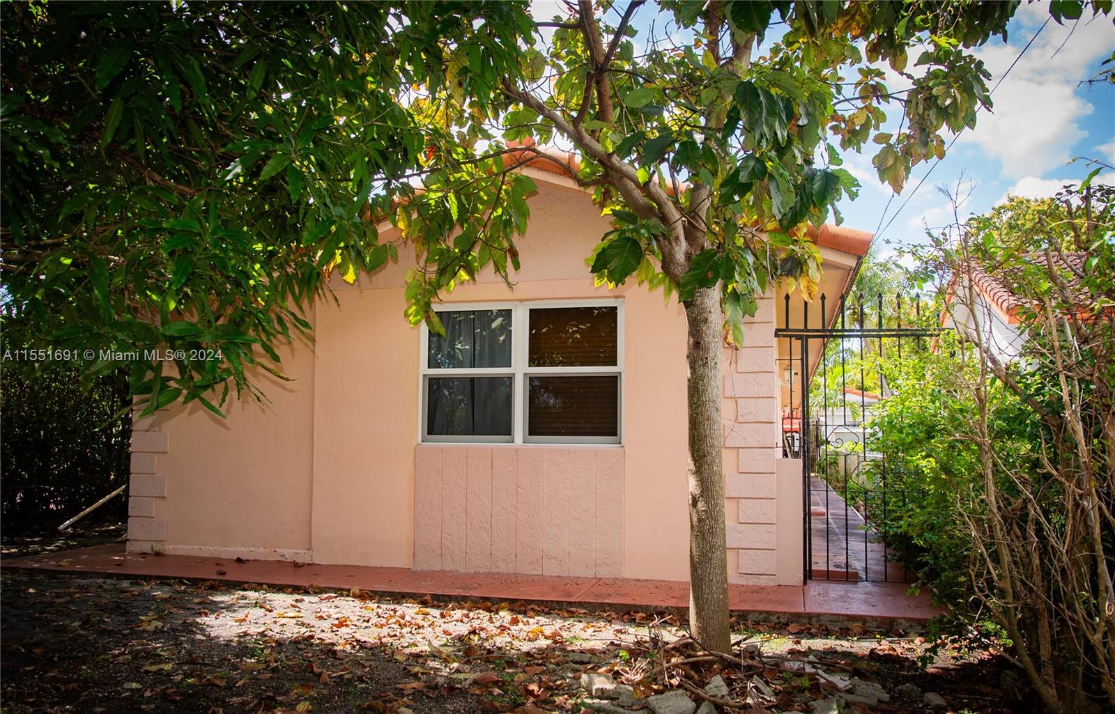 6005 Southwest 22nd Street Miami, FL 33155 - Photo 5 of 36 a front view of a house with a tree