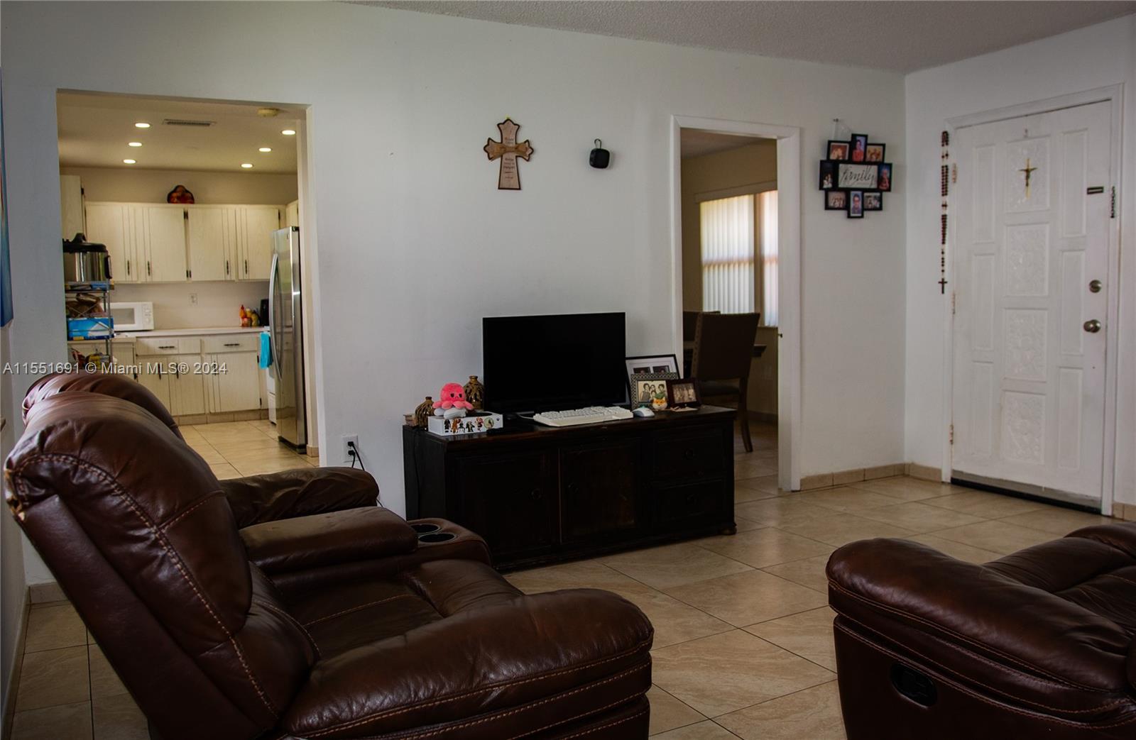 6005 Southwest 22nd Street Miami, FL 33155 - Photo 10 of 36 a living room with furniture and a flat screen tv