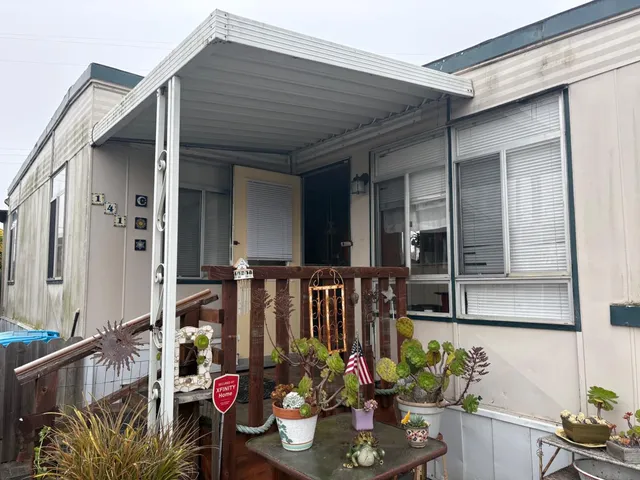 front view of a house with potted plants