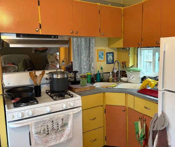 a kitchen with a stove and a refrigerator