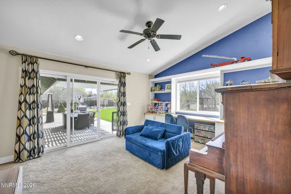 a bedroom with a large bed and a ceiling fan