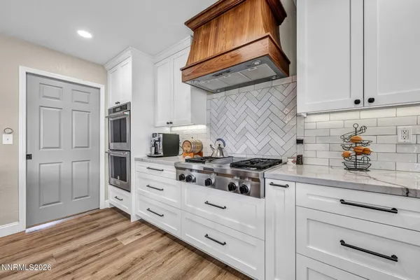 a kitchen with stainless steel appliances granite countertop a sink stove and cabinets