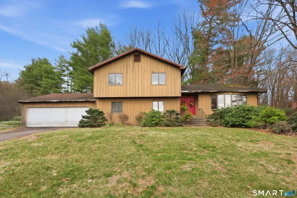 a front view of house with yard and trees
