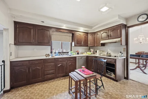 a kitchen with a sink stove and cabinets