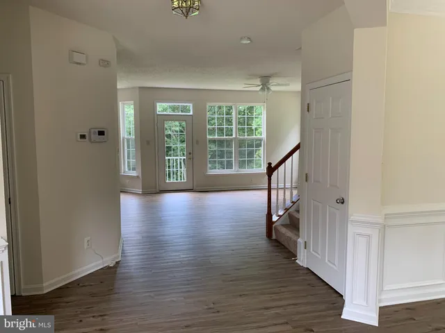 a view of an entryway with wooden floor and stairs