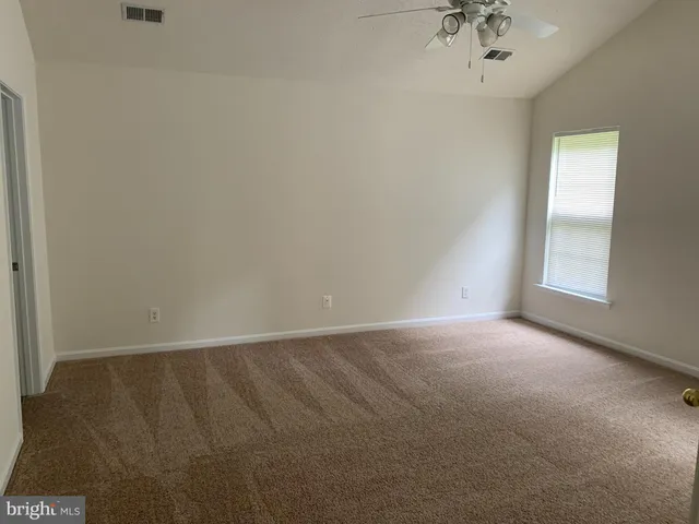 an empty room with a empty space and a window