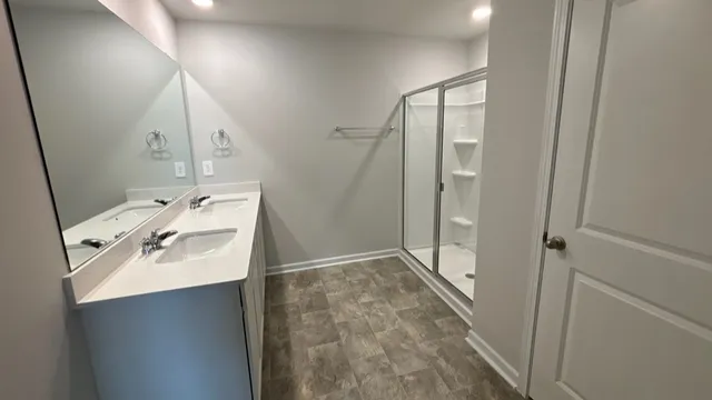 a bathroom with a sink a mirror and shower